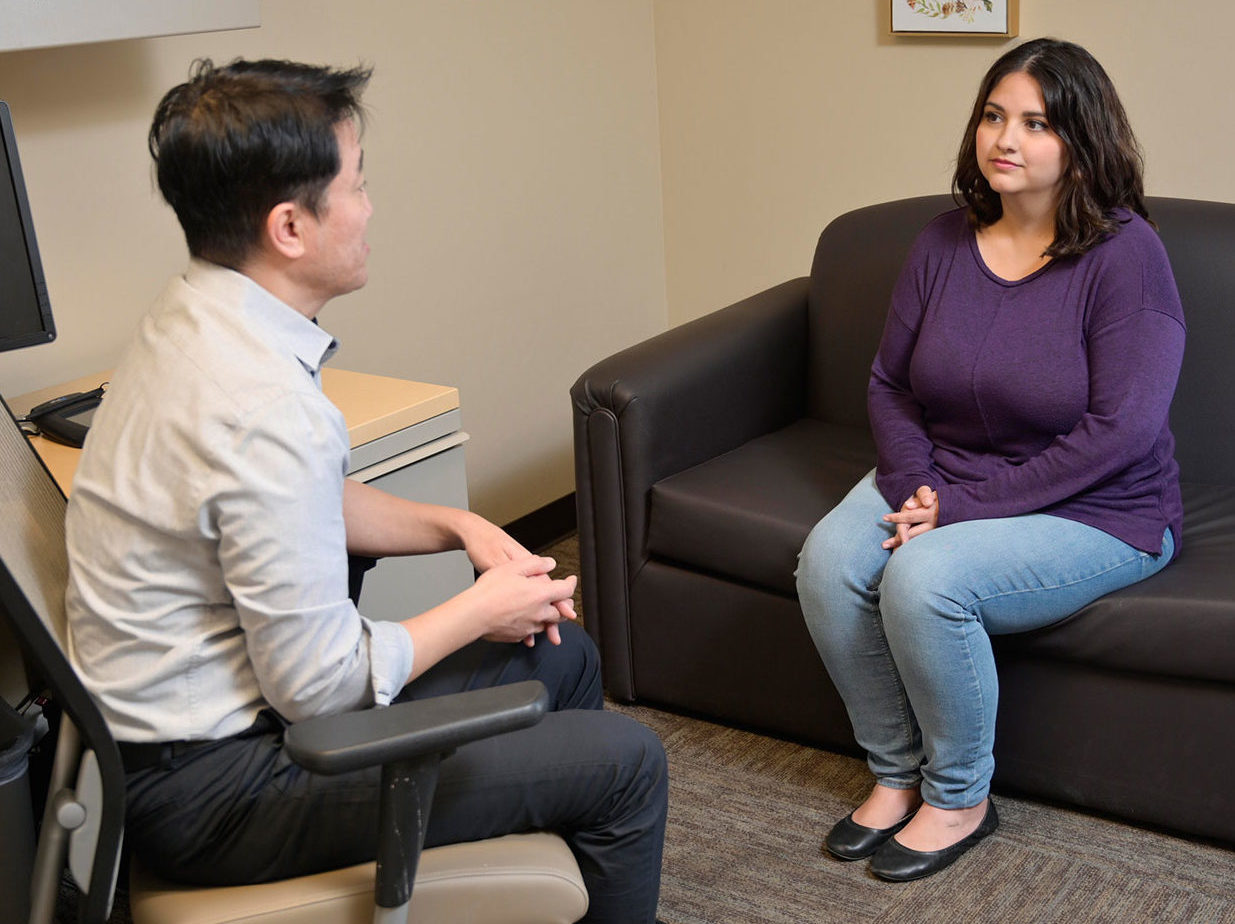 A Care Team Staff and a Member Sitting Talking to Each Other at CODAC Therapy.