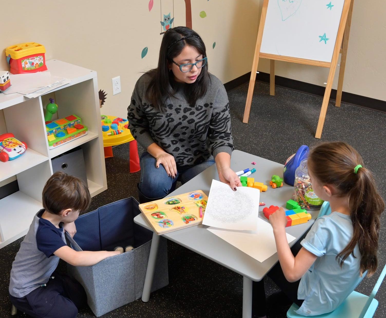 A woman in recovery at CODAC participating in nursery with children.