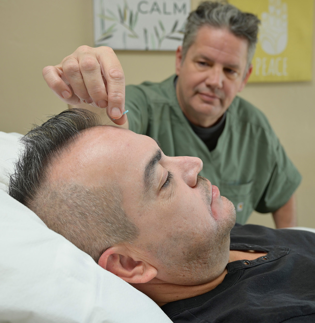 A Specialist Performing an Acupuncture Treatment on a Member at CODAC.