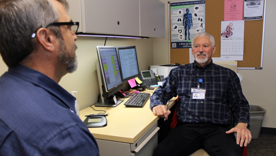 Two Men Sitting in an Office for Substance Use Treatment at CODAC. Two Men Sitting in an Office for Substance Use Treatment at CODAC.